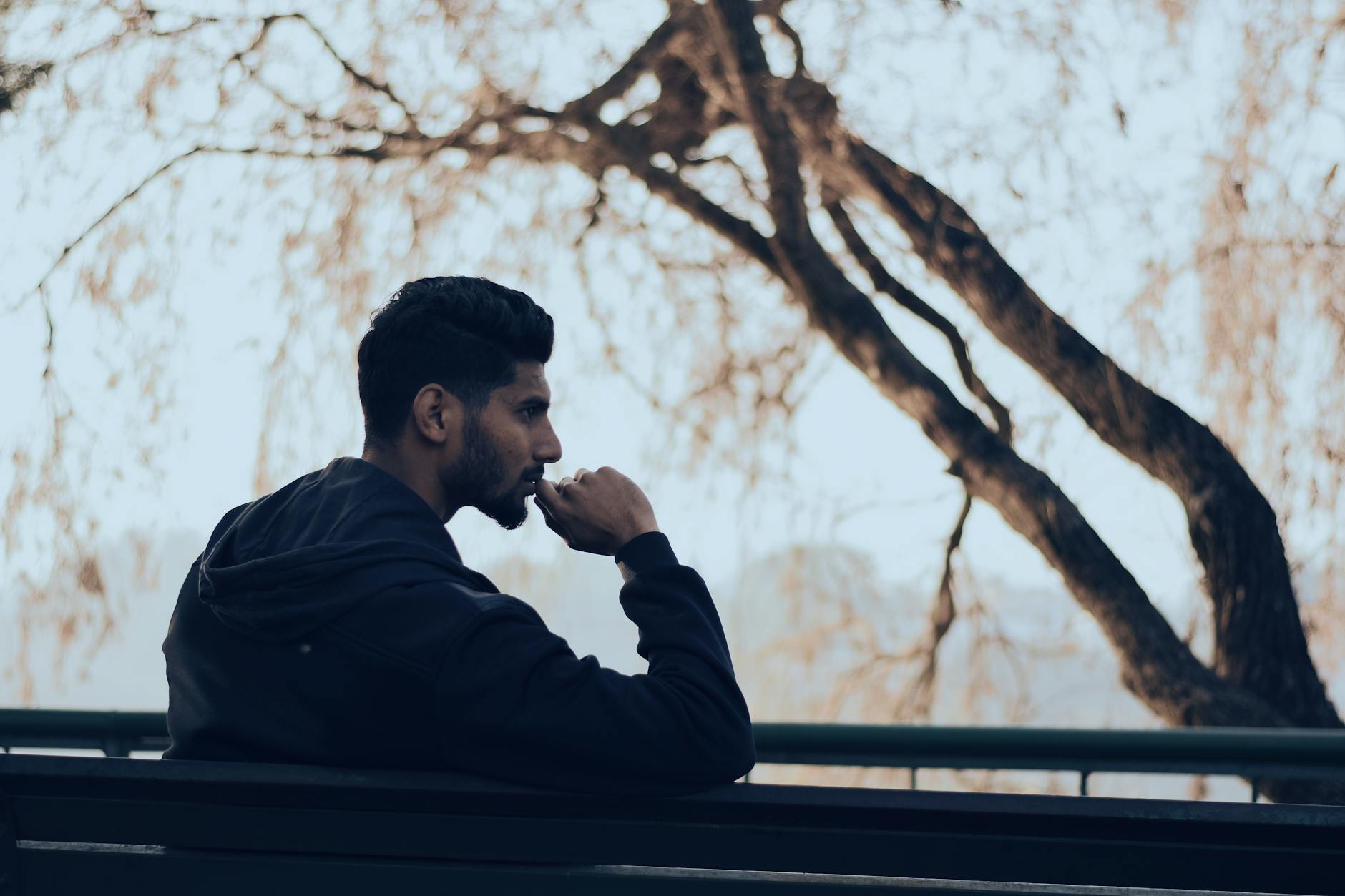 A person reflecting on patterns in their life, representing the Mentalism and Correspondence principles in practice