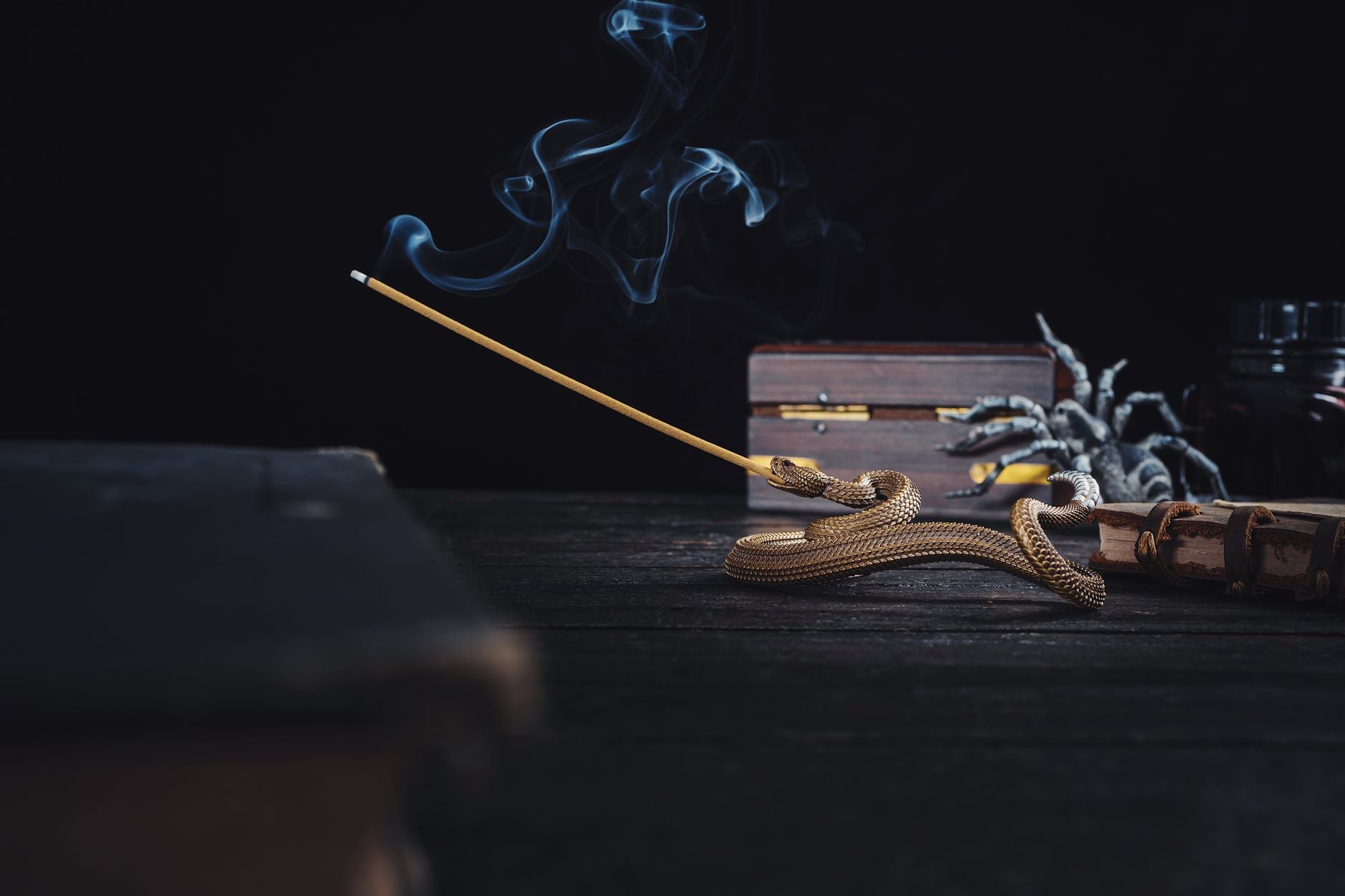 Burning incense smoke rising in a dark room — spiritual cleansing atmosphere