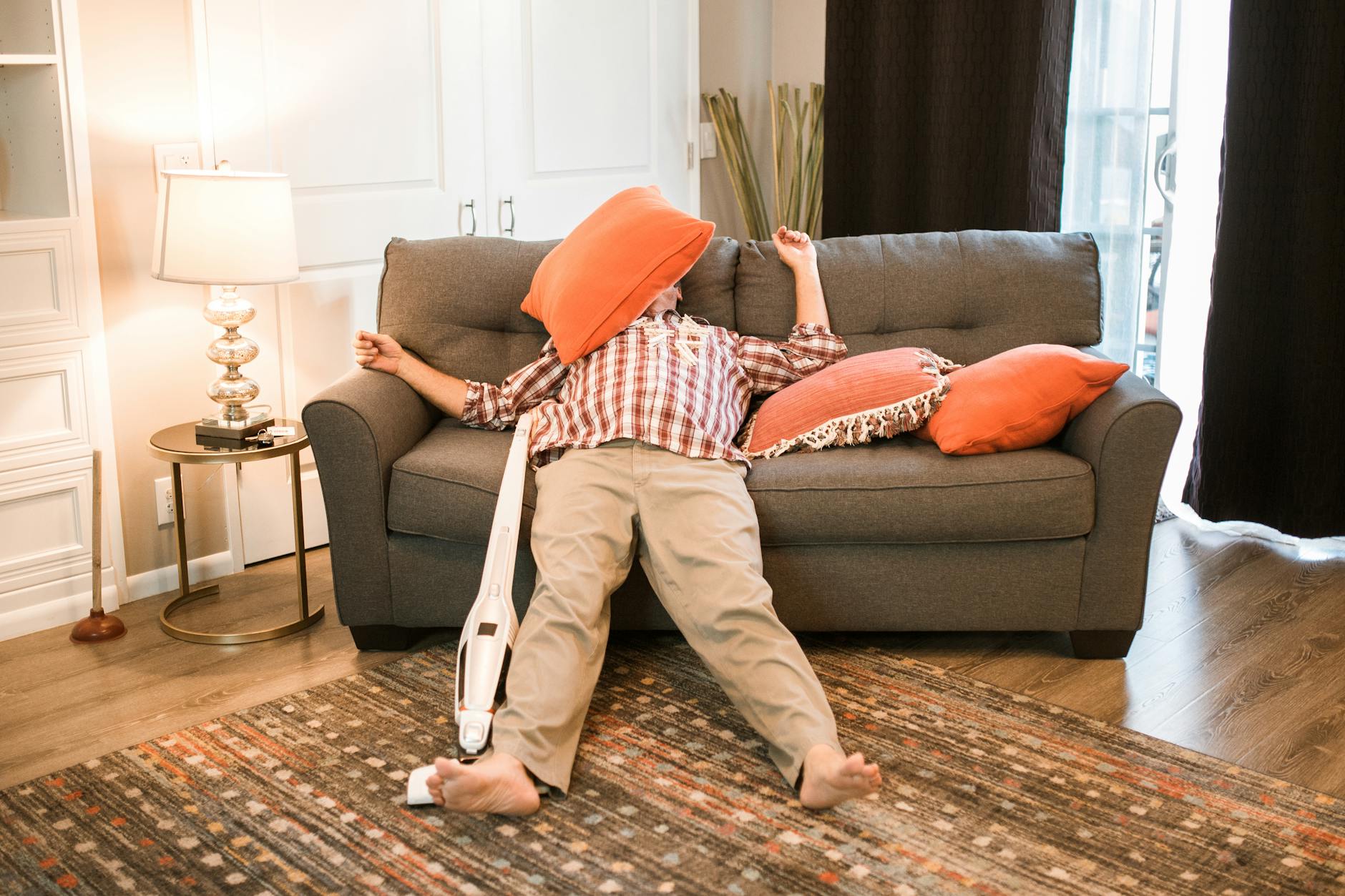 A person collapsed on a sofa, the sudden depletion that anchors the evil eye symptom cluster