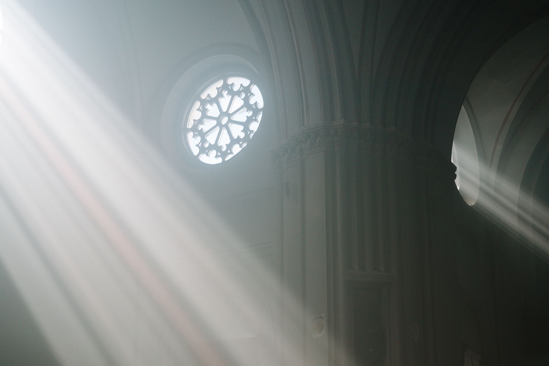 Sunbeams falling through the high windows of a cathedral, evoking the ordered hermetic angelic hierarchy described in classical grimoires