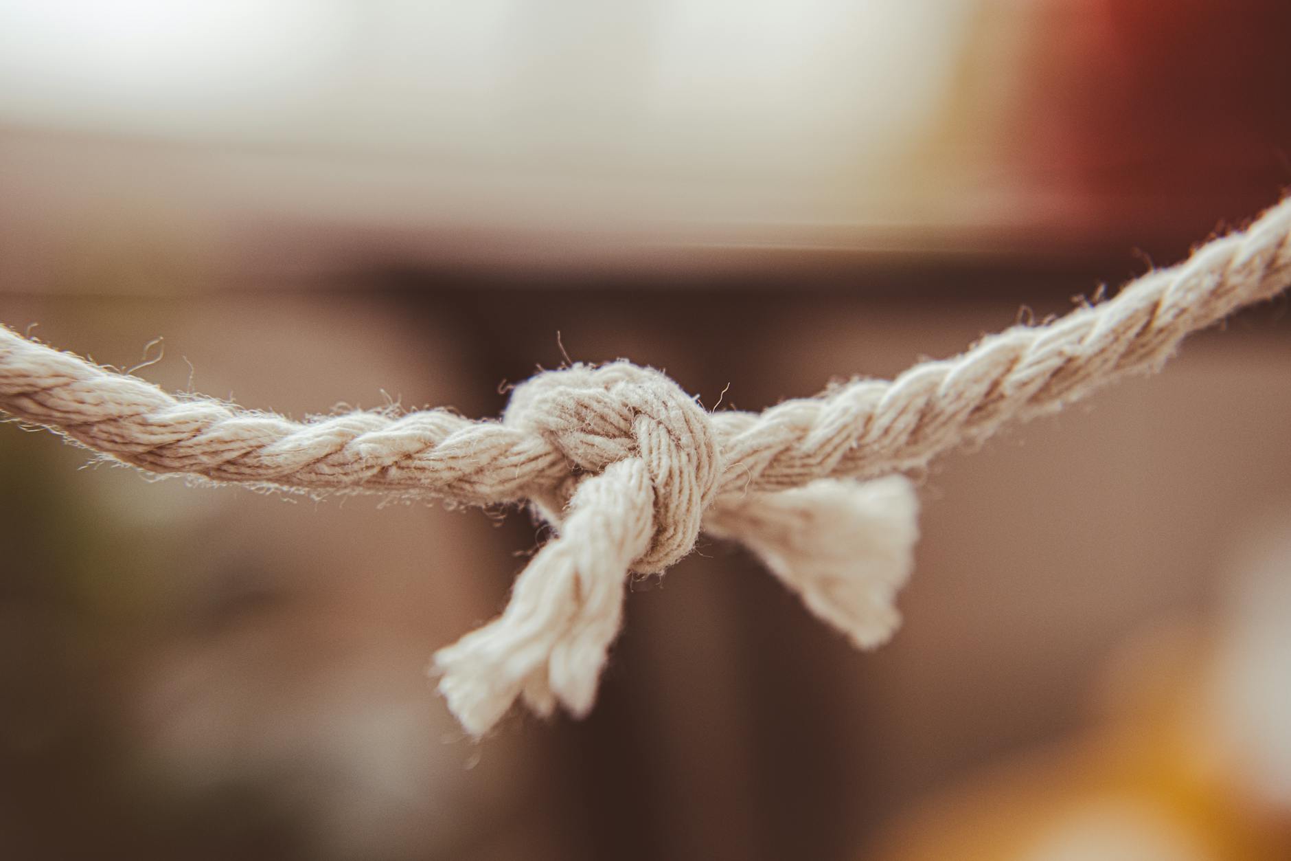 A tied rope, the unresolved loop that keeps an invisible tie active across years and distance