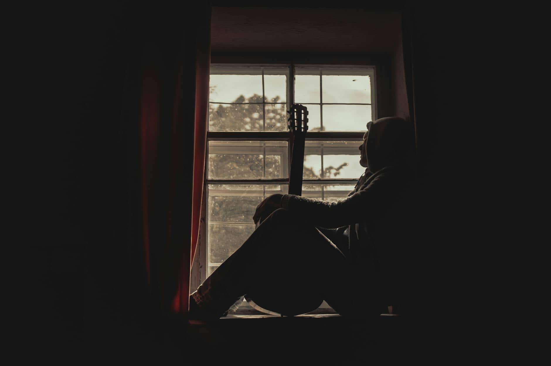 Know yourself spiritually — a person sitting alone in quiet morning light, looking inward