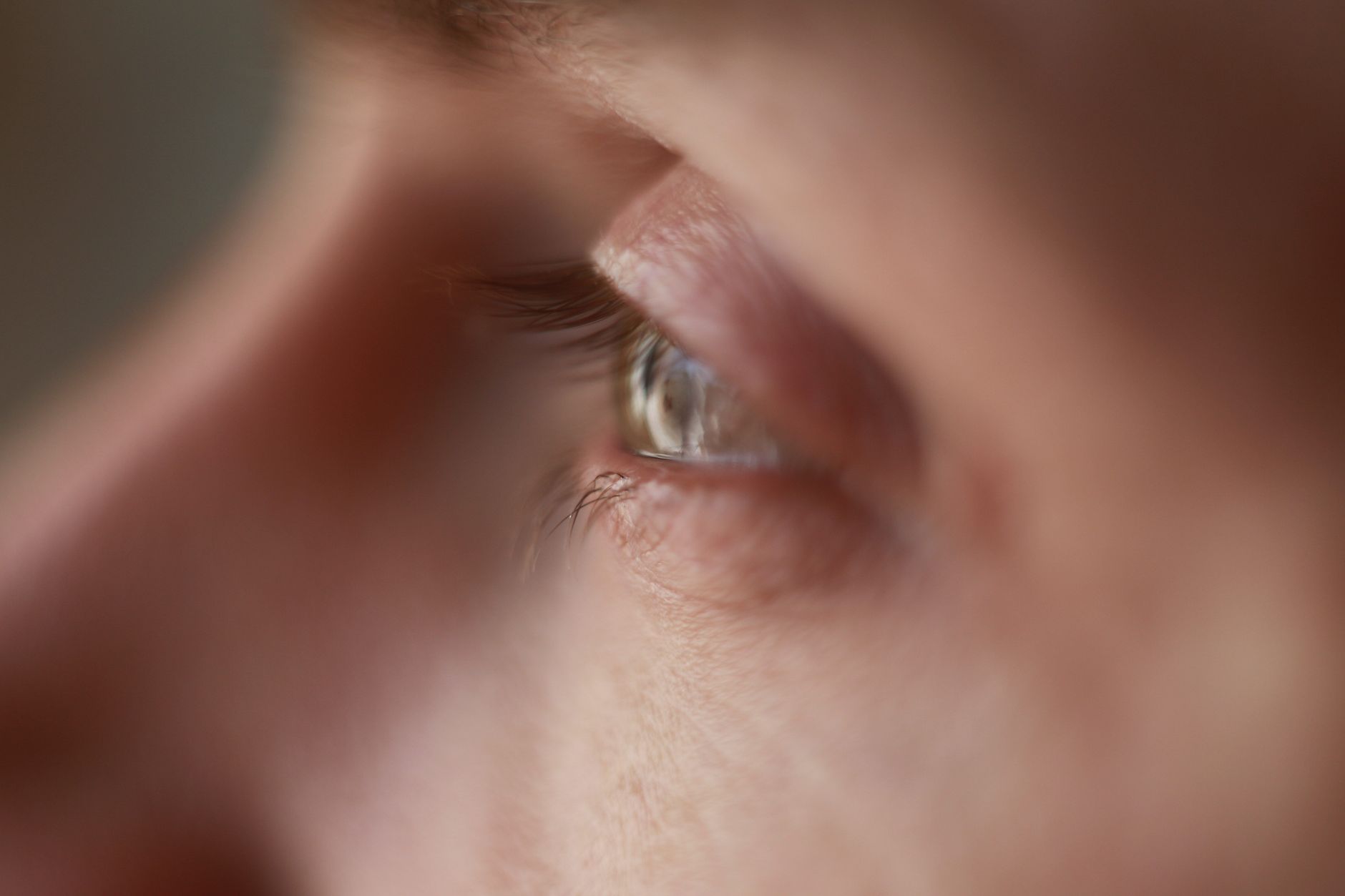 A close, focused human eye in soft daylight, representing the observer whose attention shapes what is measured