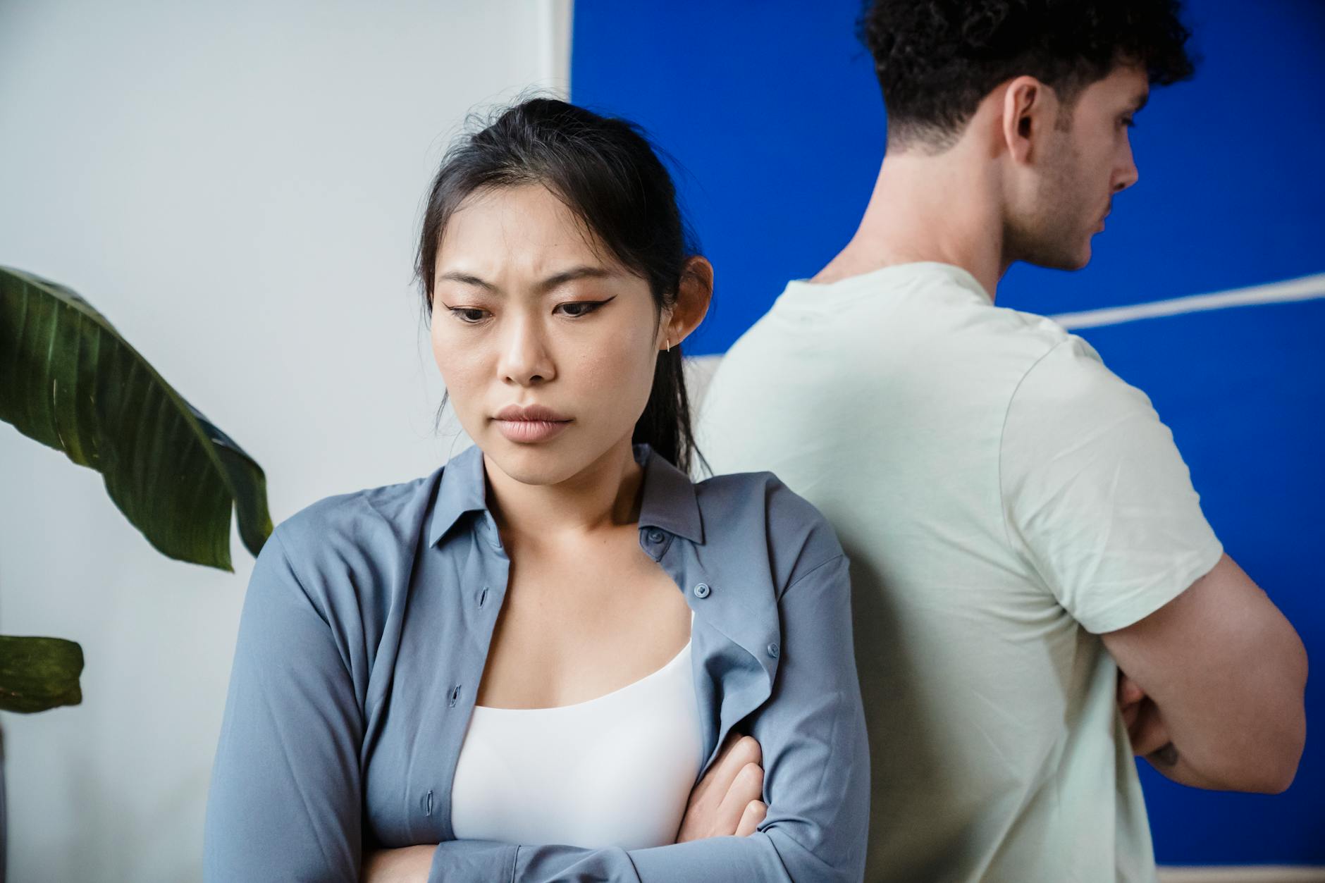 Narcissist and empath bond — a couple standing back to back, the same fit that drew them now straining