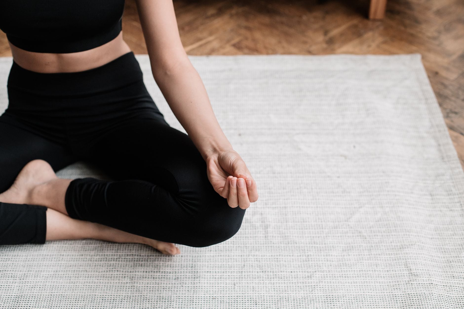 Practitioner sitting cross-legged on the floor, grounding after a ritual working