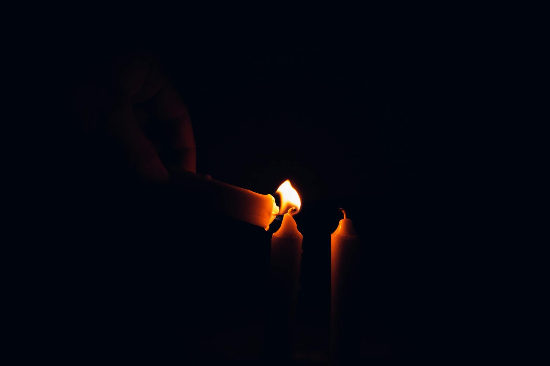 Candles burning in darkness, the deliberate intent that distinguishes a curse from the evil eye