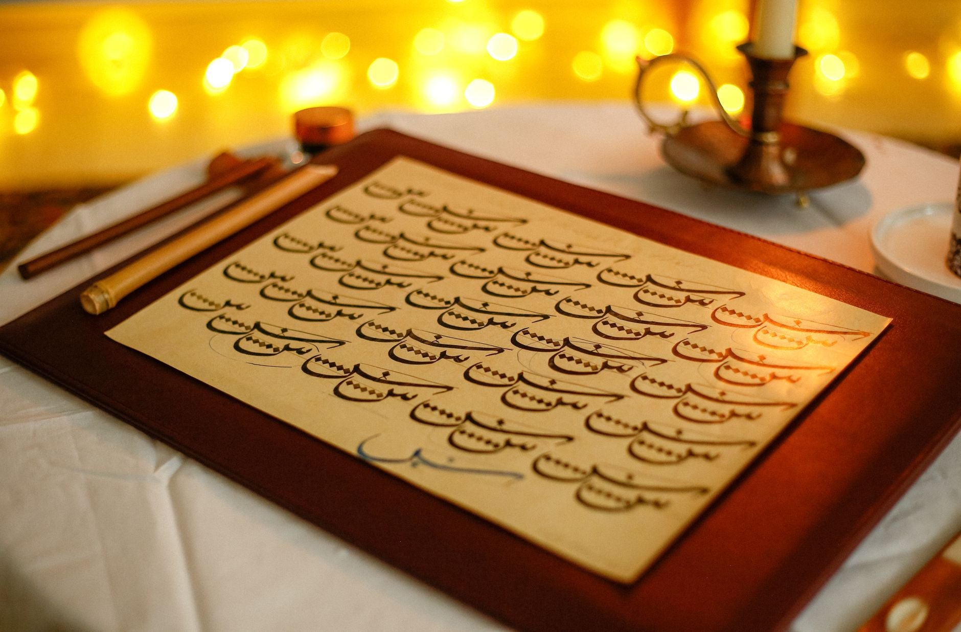 Elegant calligraphy on vintage paper with candlelight — classical Islamic-esoteric textual study