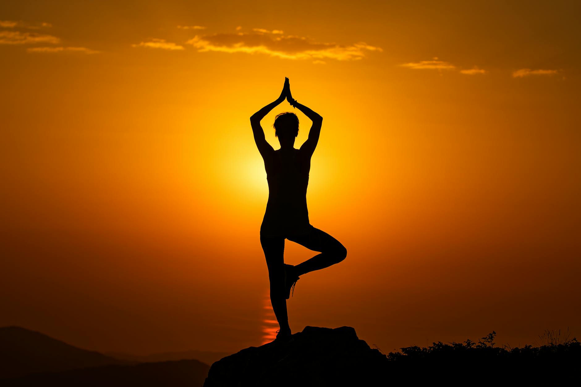 A meditation silhouette at sunrise, the deliberate positioning of consciousness meditation trains