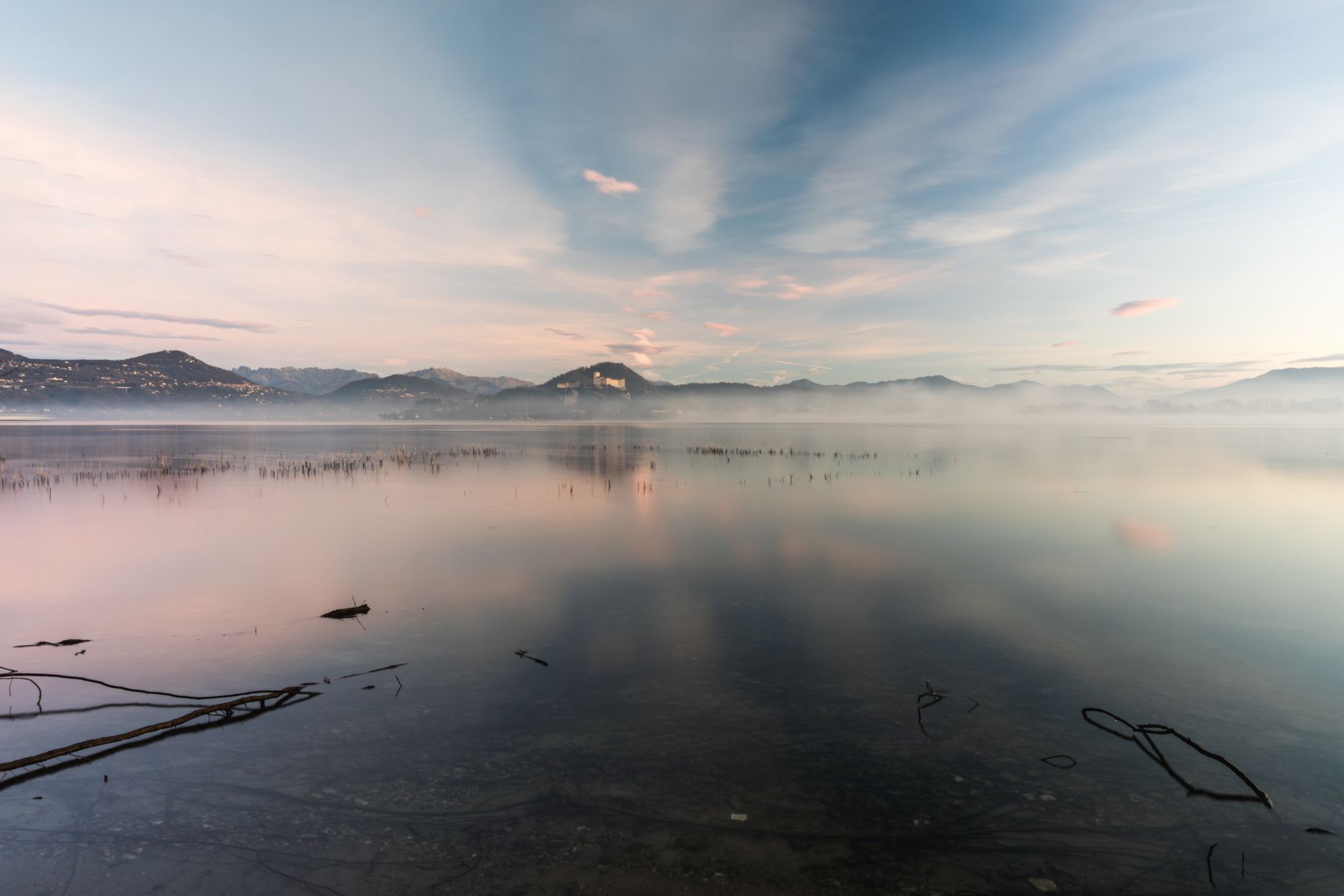 A still mountain lake in morning mist — the apparent flatness during a plateau in consciousness work