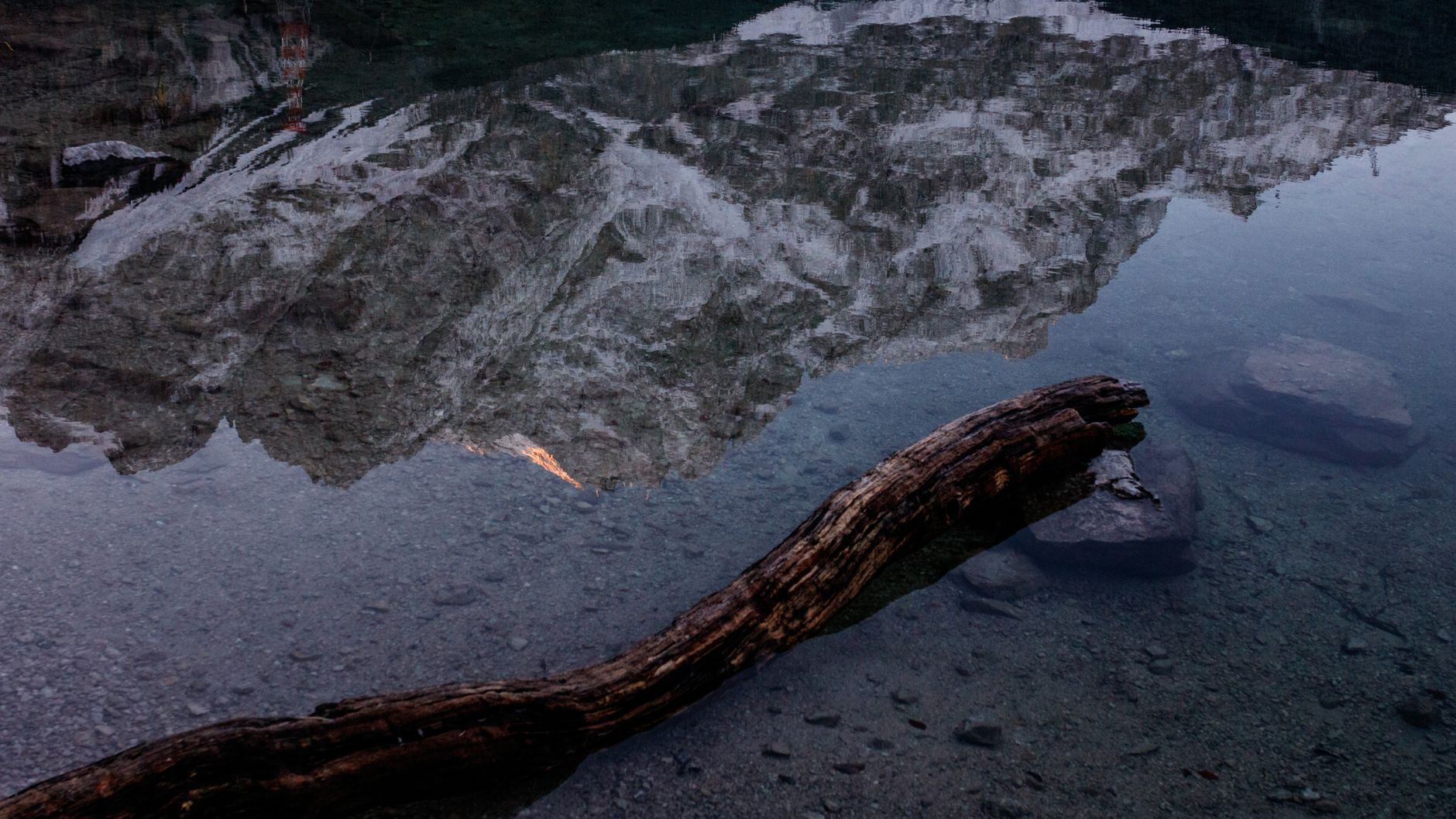 Snow-covered mountain reflected in still water, illustrating an unshaken inner field