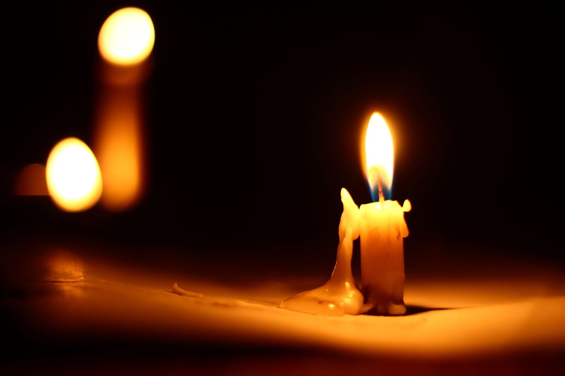 A lit candle on an altar surface, representing the focus and activation function