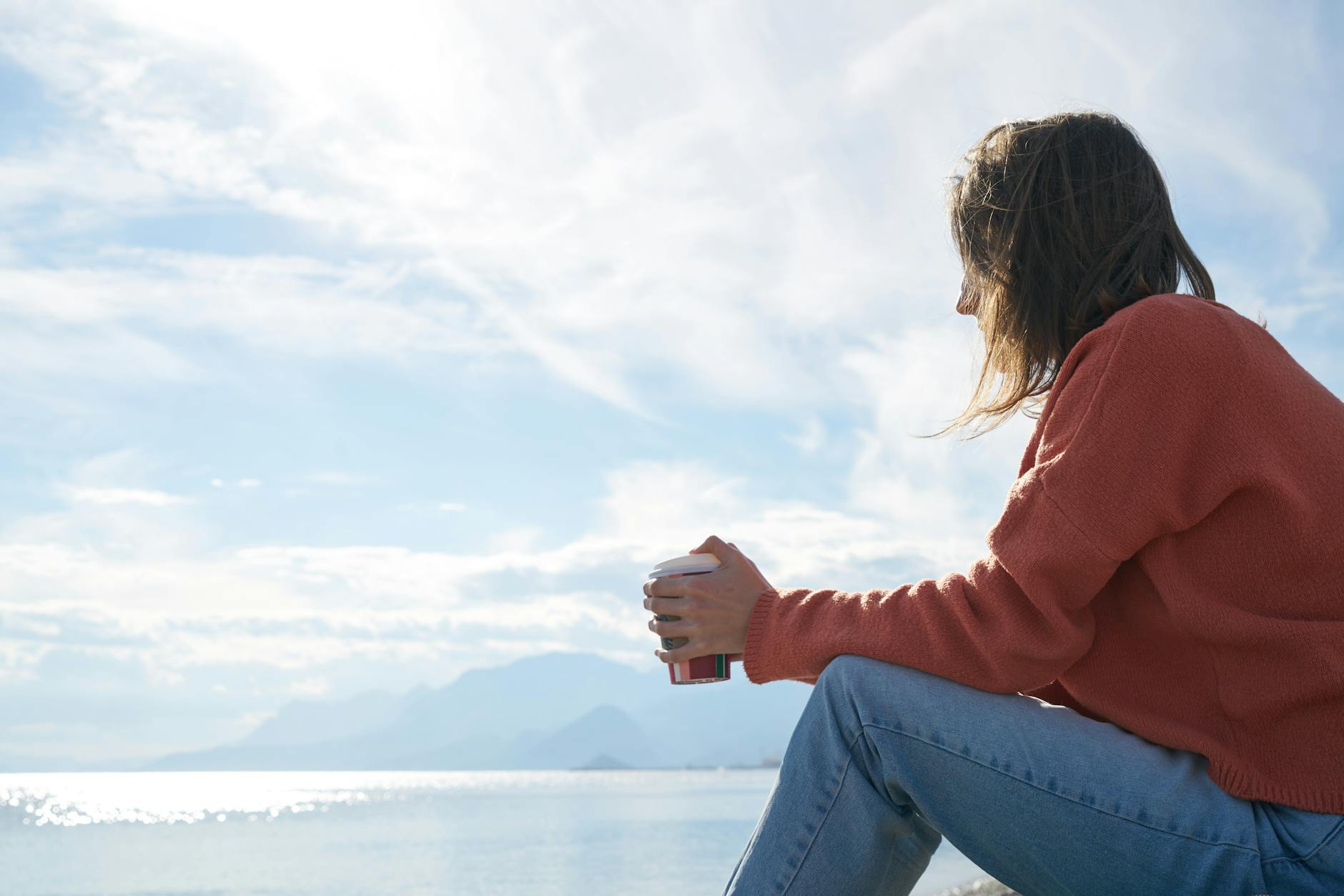 A person sitting quietly in reflection, identifying where an energetic cord is anchored in the body