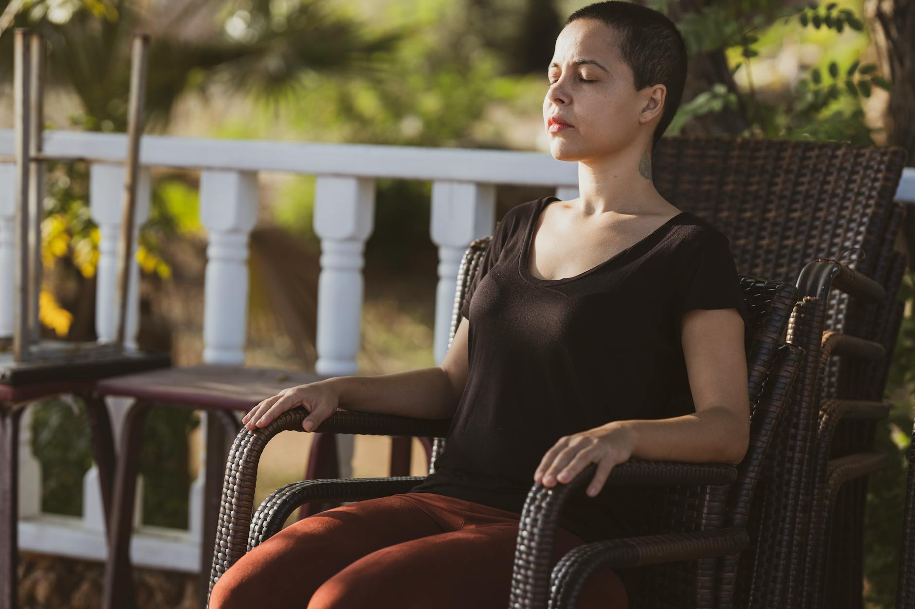 A person seated upright in focused meditation, attention training distinct from passive relaxation