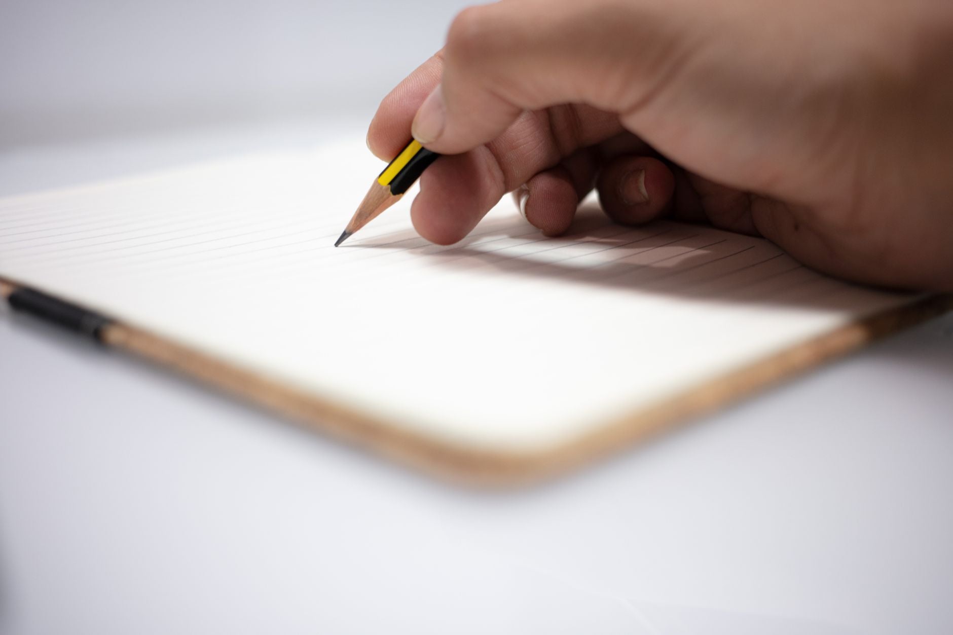 A blank notebook page with a simple short intention written on it in pencil, illustrating the one-line stated intention element of the morning routine