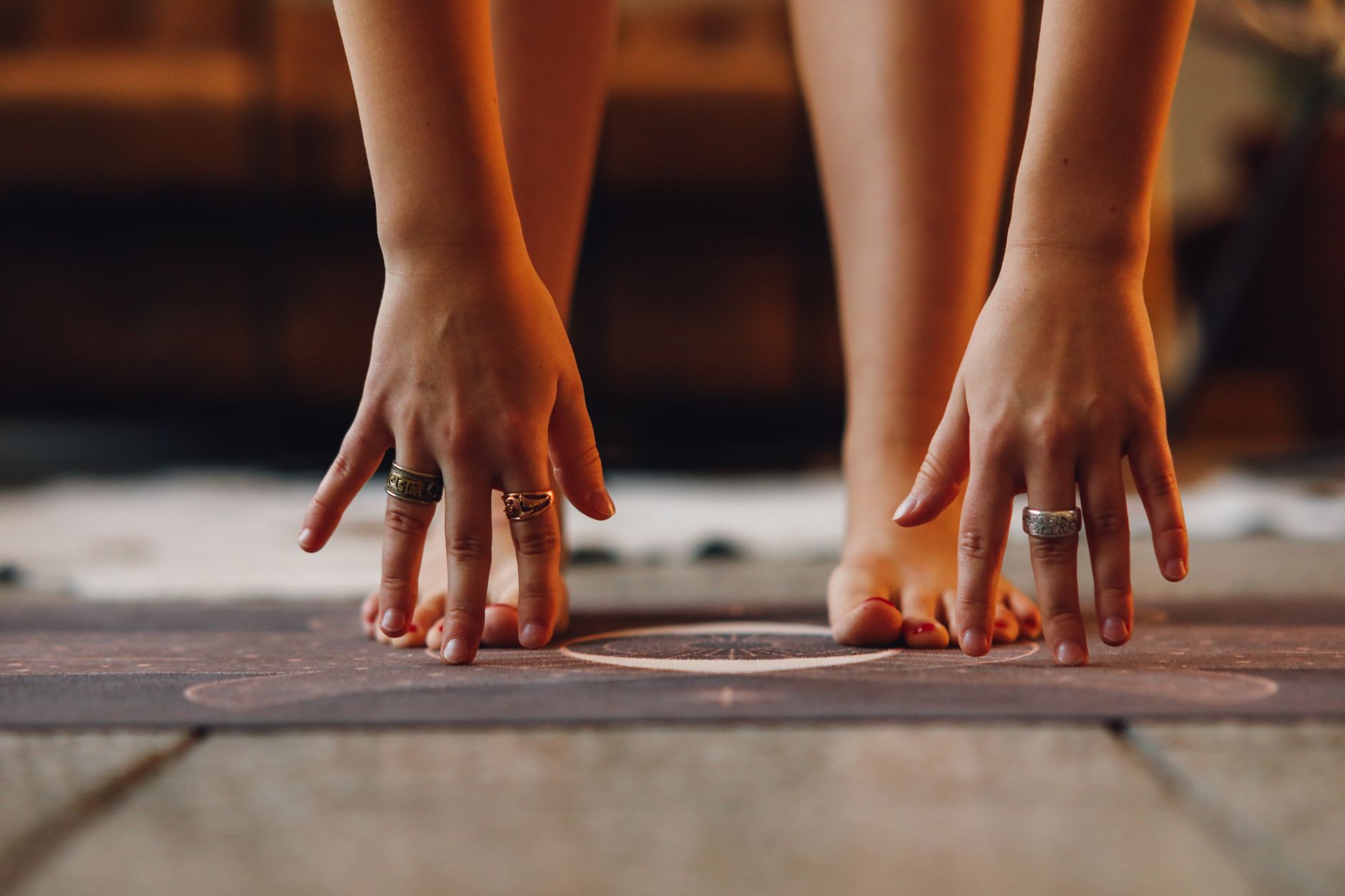 A hand resting on the chest in early morning light, illustrating a physical anchor for the inner state at the end of morning practice