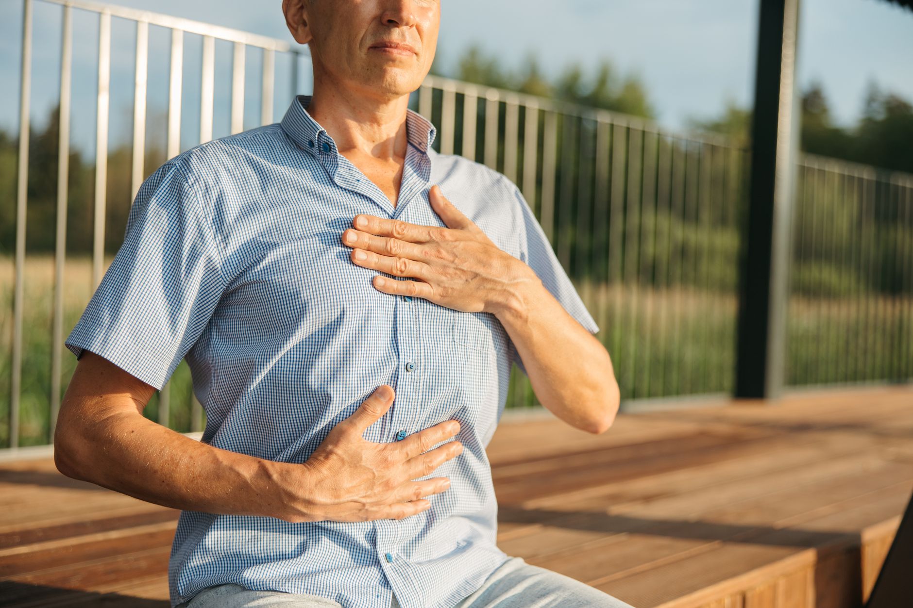 Hands resting on the chest during a breathing practice, tracking the breath as a live readout of inner state